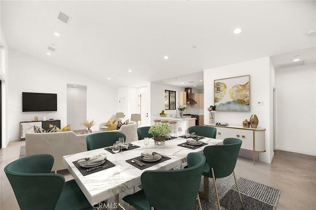 6218 Farrelo Rd, Yucca Valley, CA 92284 - dining space with concrete flooring, recessed lighting, and vaulted ceiling