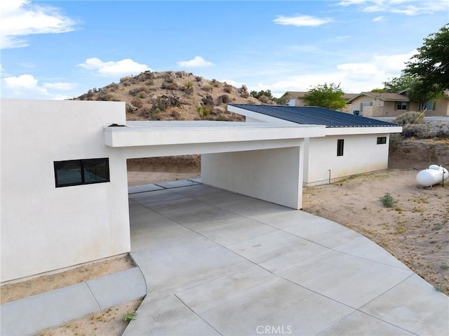 6218 Farrelo Rd, Yucca Valley, CA 92284 - view of side of home with stucco siding and metal roof
