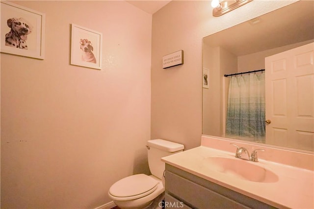 22780 Shawnee Rd, Apple Valley, CA 92308 - bathroom with toilet, vanity, a shower with shower curtain, and baseboards