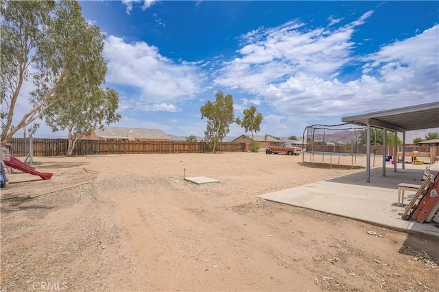 22780 Shawnee Rd, Apple Valley, CA 92308 - fenced backyard featuring a trampoline and a patio