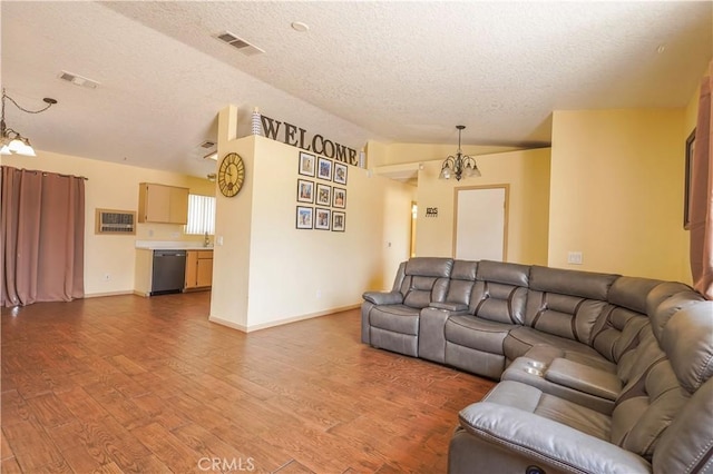 22780 Shawnee Rd, Apple Valley, CA 92308 - living area featuring a chandelier, a textured ceiling, wood finished floors, baseboards, and vaulted ceiling