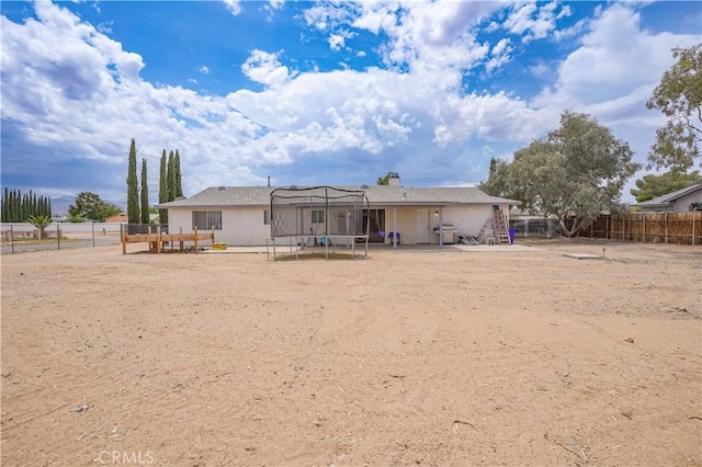 22780 Shawnee Rd, Apple Valley, CA 92308 - back of house featuring a trampoline and a chimney
