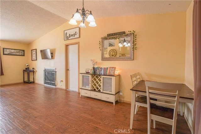 22780 Shawnee Rd, Apple Valley, CA 92308 - dining room with a chandelier, vaulted ceiling, a textured ceiling, wood finished floors, and baseboards