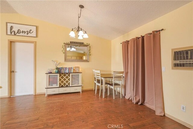 22780 Shawnee Rd, Apple Valley, CA 92308 - dining space featuring vaulted ceiling, a chandelier, wood finished floors, a textured ceiling, and baseboards