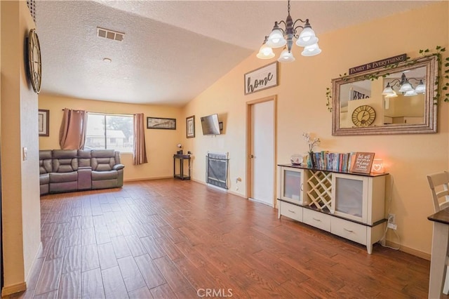 22780 Shawnee Rd, Apple Valley, CA 92308 - living area with lofted ceiling, a chandelier, wood finished floors, baseboards, and a textured ceiling