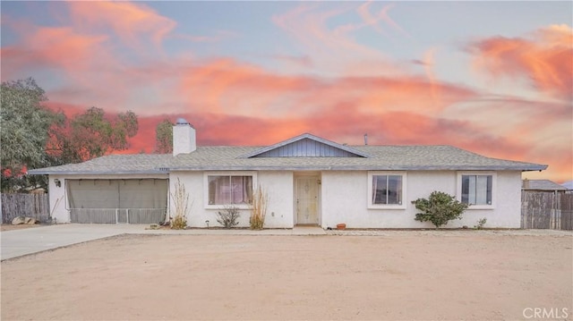 22780 Shawnee Rd, Apple Valley, CA 92308 - single story home with concrete driveway, a chimney, a garage, stucco siding, and roof with shingles