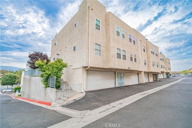 18209 Sierra Unit 45, Canyon Country, CA 91351 - view of property featuring stairway and a garage