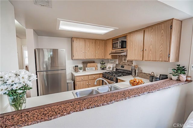18209 Sierra Unit 45, Canyon Country, CA 91351 - kitchen featuring appliances with stainless steel finishes, under cabinet range hood, a sink, backsplash, and light brown cabinetry