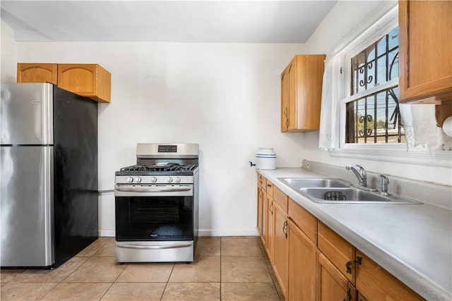 614 N Spring Ave, Compton, CA 90221 - kitchen featuring appliances with stainless steel finishes, a sink, baseboards, light countertops, and light tile patterned floors