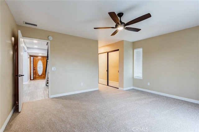 1320 Shadow Cir, Upland, CA 91784 - unfurnished bedroom with light colored carpet, baseboards, a ceiling fan, and a closet