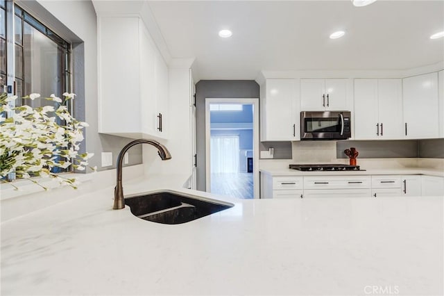 1320 Shadow Cir, Upland, CA 91784 - kitchen featuring stainless steel microwave, a sink, white cabinets, recessed lighting, and gas stovetop