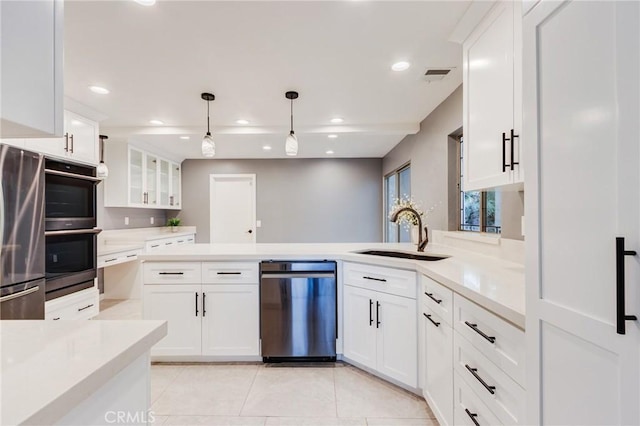 1320 Shadow Cir, Upland, CA 91784 - kitchen with stainless steel appliances, a sink, a peninsula, white cabinetry, and light countertops