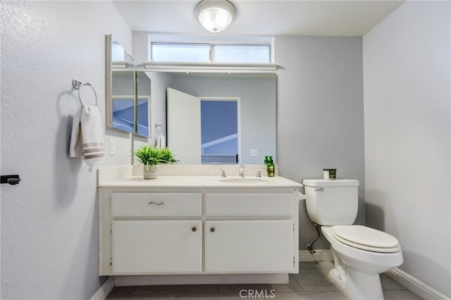 1320 Shadow Cir, Upland, CA 91784 - bathroom featuring toilet, baseboards, vanity, tile patterned floors, and a textured wall