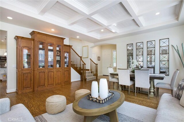15 Beacon, Ladera Ranch, CA 92694 - living room with wood finished floors, coffered ceiling, arched walkways, beamed ceiling, and stairway
