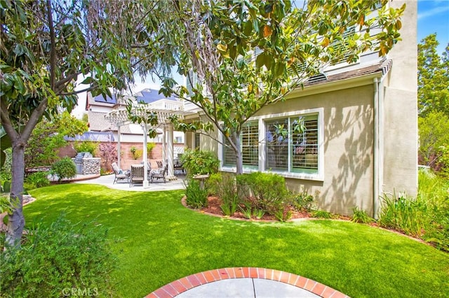 15 Beacon, Ladera Ranch, CA 92694 - rear view of house with stucco siding, a patio, and a lawn