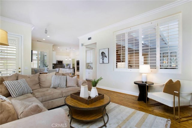 15 Beacon, Ladera Ranch, CA 92694 - living room featuring crown molding, wood finished floors, baseboards, and recessed lighting