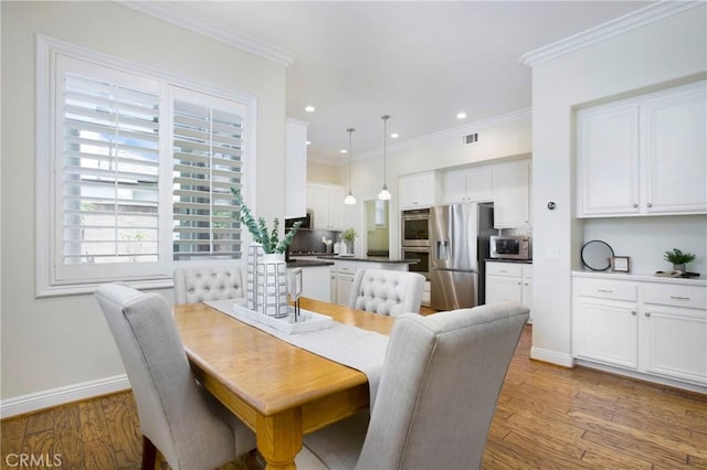 15 Beacon, Ladera Ranch, CA 92694 - dining space with wood finished floors, recessed lighting, crown molding, and baseboards