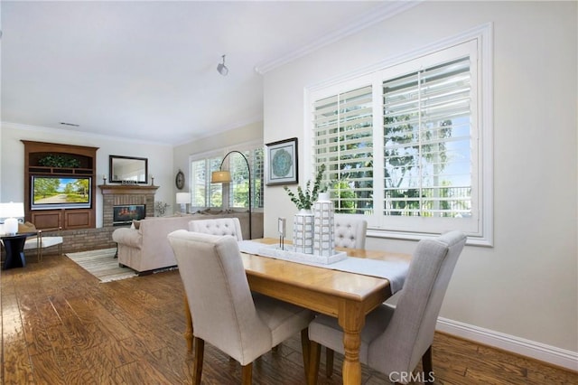 15 Beacon, Ladera Ranch, CA 92694 - dining space featuring wood finished floors, crown molding, a brick fireplace, and baseboards