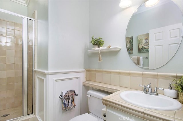 15 Beacon, Ladera Ranch, CA 92694 - bathroom with a stall shower, toilet, vanity, and wainscoting