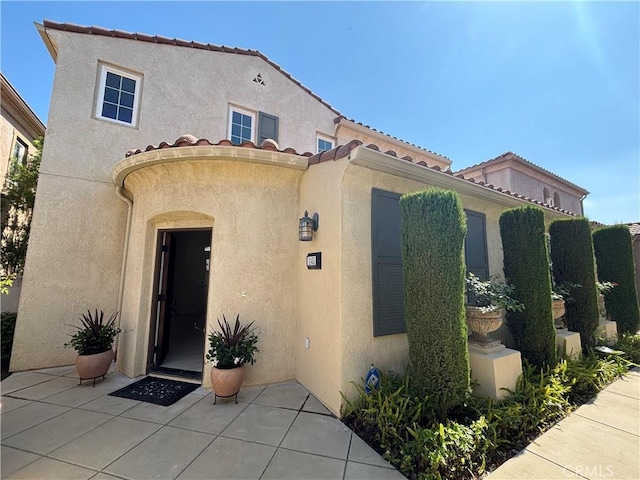 11451 Ghiberti Way, Porter Ranch, CA 91326 - entrance to property featuring stucco siding, a tile roof, and a patio
