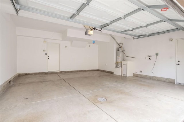 11451 Ghiberti Way, Porter Ranch, CA 91326 - garage with strapped water heater, a garage door opener, and baseboards