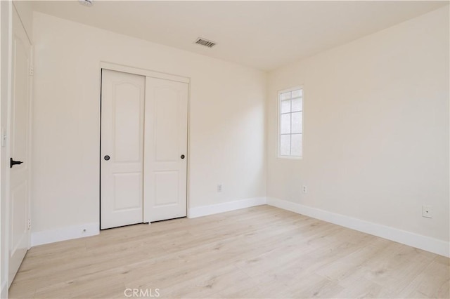 11451 Ghiberti Way, Porter Ranch, CA 91326 - unfurnished bedroom with light wood-style floors, baseboards, and a closet