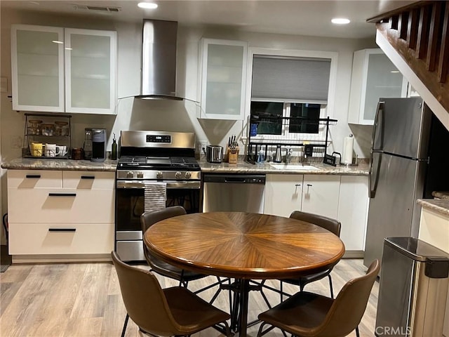 2557 Whispering Pines Dr, Running Springs, CA 92382 - kitchen featuring appliances with stainless steel finishes, wall chimney range hood, white cabinets, recessed lighting, and glass insert cabinets
