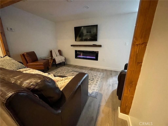 2557 Whispering Pines Dr, Running Springs, CA 92382 - living area with a glass covered fireplace, wood finished floors, and baseboards