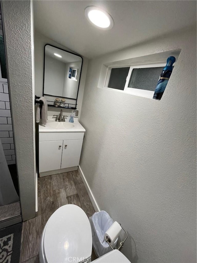 2557 Whispering Pines Dr, Running Springs, CA 92382 - bathroom featuring toilet, vanity, wood finished floors, baseboards, and a textured wall