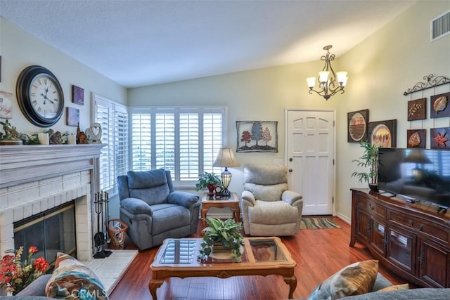 9793 Louise Way, Rancho Cucamonga, CA 91730 - living room with lofted ceiling, wood finished floors, a chandelier, and a brick fireplace