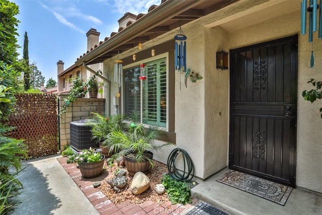 9793 Louise Way, Rancho Cucamonga, CA 91730 - entrance to property featuring stucco siding, a chimney, and central AC