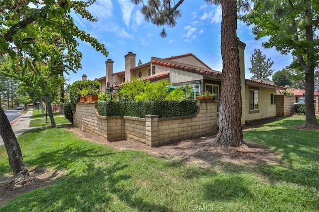 9793 Louise Way, Rancho Cucamonga, CA 91730 - back of house with stucco siding, a lawn, and a tile roof