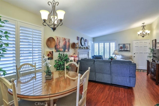 9793 Louise Way, Rancho Cucamonga, CA 91730 - dining space featuring a chandelier, dark wood-style floors, vaulted ceiling, and a fireplace