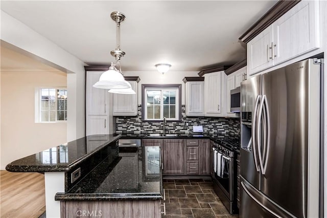 21323 Martin St, Carson, CA 90745 - kitchen with appliances with stainless steel finishes, decorative backsplash, a sink, dark stone counters, and white cabinetry