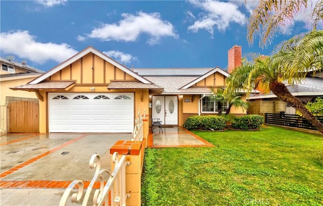21323 Martin St, Carson, CA 90745 - view of front of house featuring driveway, an attached garage, board and batten siding, roof mounted solar panels, and a chimney