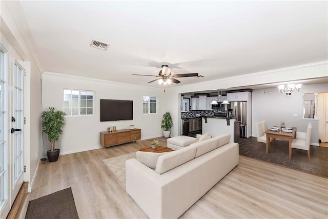 21323 Martin St, Carson, CA 90745 - living room with light wood finished floors, a chandelier, ornamental molding, baseboards, and ceiling fan