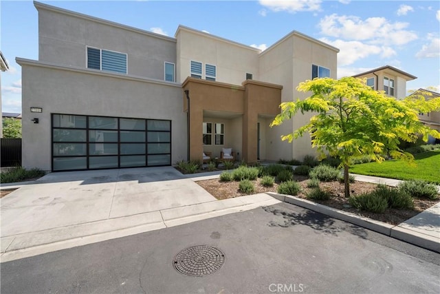 27010 Declaration Rd, Valencia, CA 91381 - view of front of home with stucco siding, concrete driveway, and an attached garage