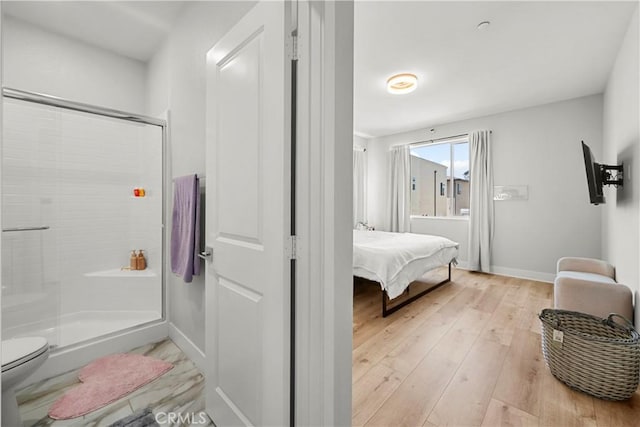 27010 Declaration Rd, Valencia, CA 91381 - full bathroom with a shower stall, toilet, hardwood / wood-style flooring, and baseboards