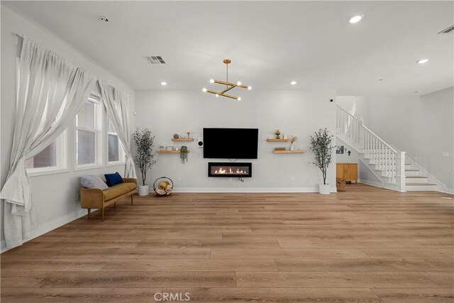 27010 Declaration Rd, Valencia, CA 91381 - unfurnished living room featuring light wood-style floors, stairway, recessed lighting, a chandelier, and baseboards