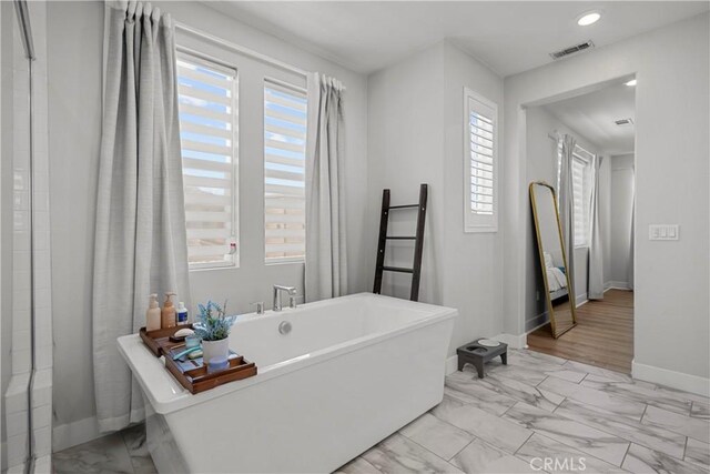 27010 Declaration Rd, Valencia, CA 91381 - full bath featuring marble finish flooring, healthy amount of natural light, a freestanding bath, baseboards, and recessed lighting