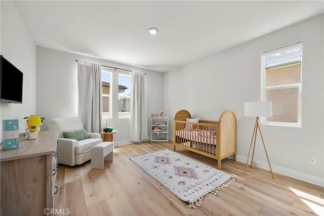 27010 Declaration Rd, Valencia, CA 91381 - bedroom with light wood-type flooring, a crib, and baseboards