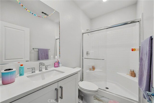 27010 Declaration Rd, Valencia, CA 91381 - full bathroom featuring a stall shower, vanity, toilet, and marble look tiles