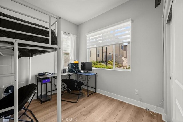 27010 Declaration Rd, Valencia, CA 91381 - bedroom featuring baseboards, light wood-type flooring, and an office area