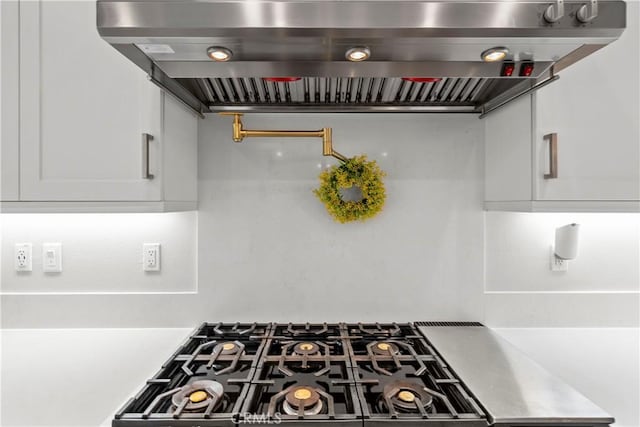 27010 Declaration Rd, Valencia, CA 91381 - kitchen featuring island exhaust hood, gas cooktop, white cabinets, and light countertops