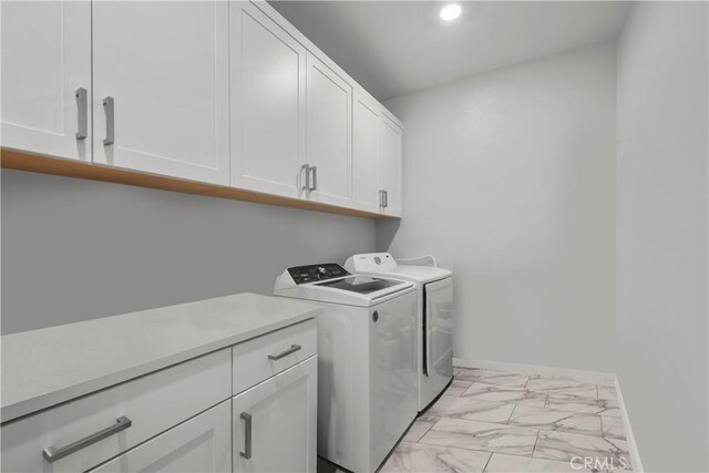27010 Declaration Rd, Valencia, CA 91381 - laundry room featuring cabinet space, light marble finish flooring, washing machine and dryer, recessed lighting, and baseboards
