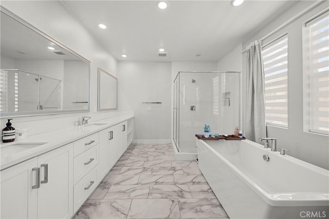 27010 Declaration Rd, Valencia, CA 91381 - full bath with marble finish floors, recessed lighting, plenty of natural light, a soaking tub, and a shower stall
