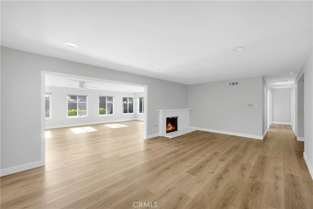 12151 Reagan St, Los Alamitos, CA 90720 - unfurnished living room featuring a fireplace, light wood-style flooring, baseboards, recessed lighting, and ceiling fan
