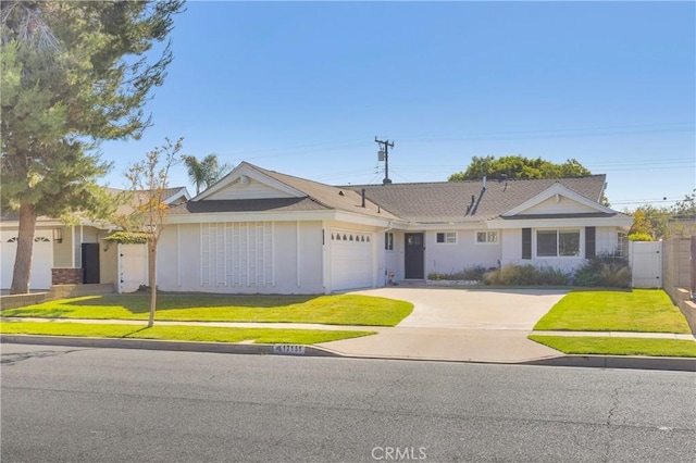 12151 Reagan St, Los Alamitos, CA 90720 - single story home featuring a garage, concrete driveway, and a gate