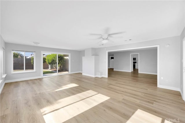 12151 Reagan St, Los Alamitos, CA 90720 - unfurnished living room featuring ceiling fan, baseboards, and light wood-style floors
