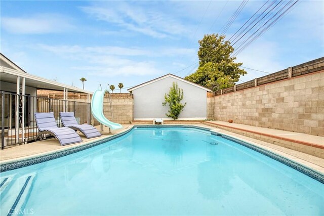 1158 N Ivescrest Ave, Covina, CA 91724 - view of pool featuring a water slide, a fenced backyard, and a diving board